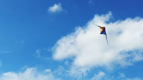 Low angle view of kite flying against blue sky