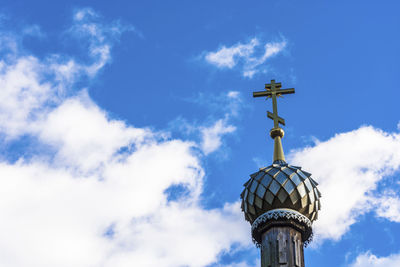 Low angle view of cross against building