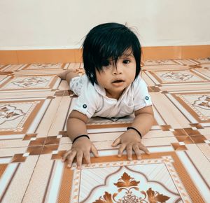 Portrait of cute girl sitting at home