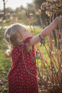 Close-up of girl with plants in foreground