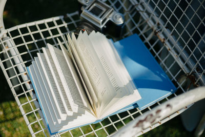 Close-up of books on fence