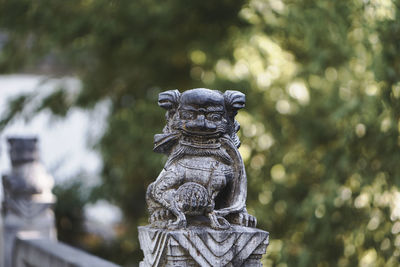 Statue against trees