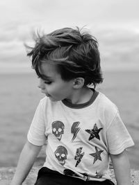 Cute boy standing on beach