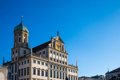 Low angle view of building against clear blue sky