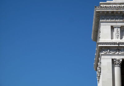 Low angle view of built structure against clear blue sky