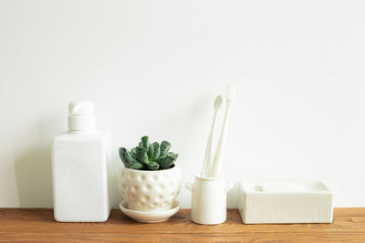 Close-up of white bottles on table