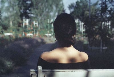 Rear view of woman sitting outdoors