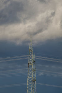 Low angle view of communications tower against sky