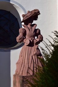 Low angle view of statue against building