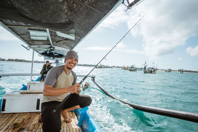 Portrait of man sitting on boat in sea