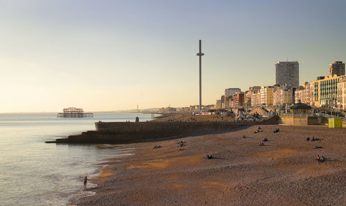 Panoramic view of sea and buildings against sky during sunset