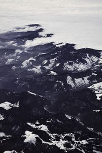 Aerial view of rocks in sea against sky