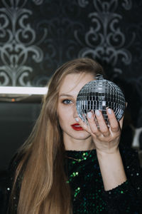 New year eve night club party. chic image of beautiful girl in sparkles evening dress with disco