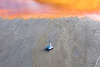 High angle view of umbrella on land against sky during sunset