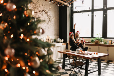 Happy funny girls celebrate christmas holidays and new year in a cozy house