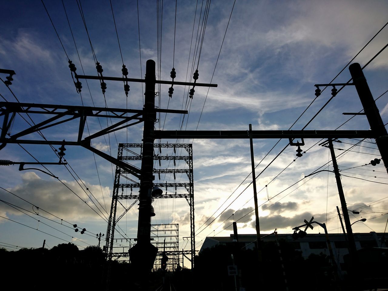 LOW ANGLE VIEW OF SILHOUETTE CRANE AGAINST CLOUDY SKY