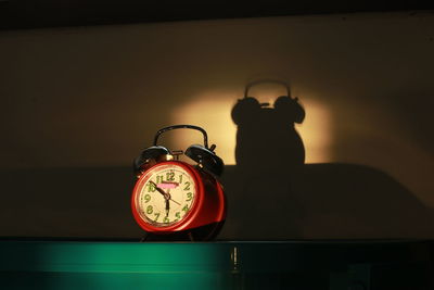 Alarm clock on table against wall