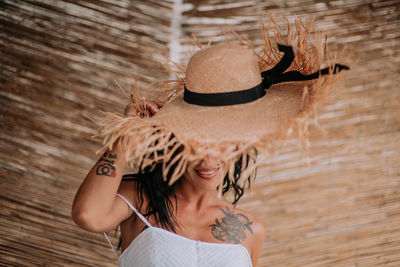 Portrait of smiling young woman wearing hat