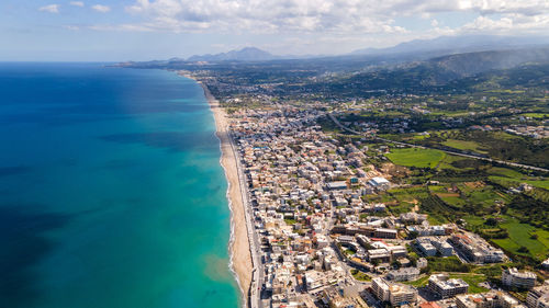 High angle view of townscape by sea against sky