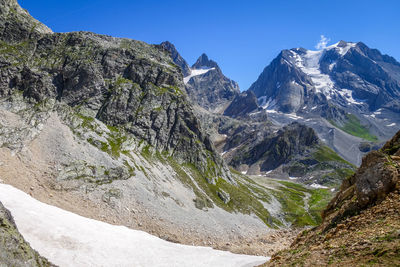 Panoramic view of landscape and mountains against clear blue sky