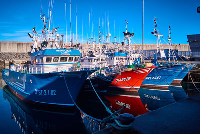 Boats moored at harbor