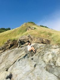 Full length of man on rock against clear sky