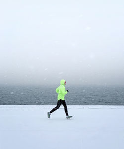 Full length of man skiing on snow land