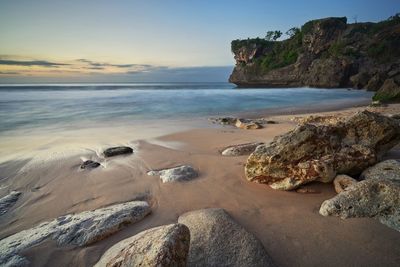 Scenic view of beach against sky during sunset