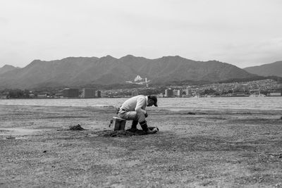 Man on field against mountains