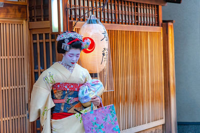 Woman with umbrella at temple