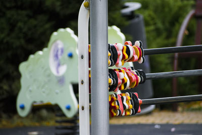 Close-up of clothespins hanging on railing