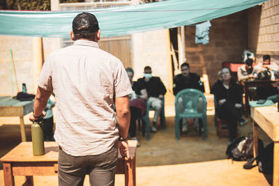 Rear view of people listening to a speak