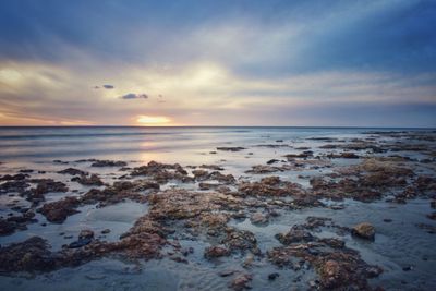 Scenic view of sea against sky at sunset