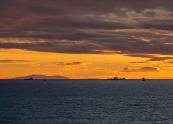 Scenic view of sea against orange sky