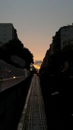 Railroad tracks against sky during sunset