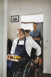 Disabled man with corn and breads at home