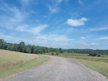 Empty road along countryside landscape