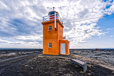 Lighthouse against cloudy sky