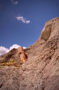 Low angle view of mountain against blue sky