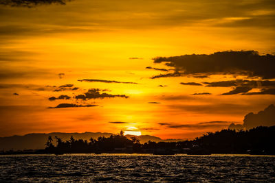 Scenic view of sea against romantic sky at sunset