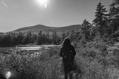 Rear view of woman walking on field