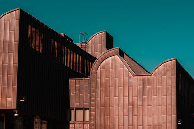 Low angle view of building against clear blue sky