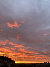 Silhouette buildings against sky during sunset