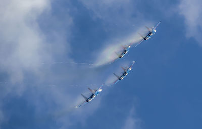 Low angle view of airshow against sky