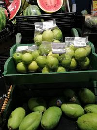 Green fruits for sale in market