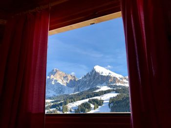 Scenic view of snowcapped mountains seen through window