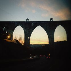 Bridge over river at sunset