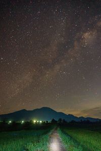 Scenic view of landscape against sky at night