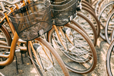 Close-up of bicycles parked in row at city