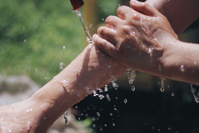 Close-up of water drops on hand